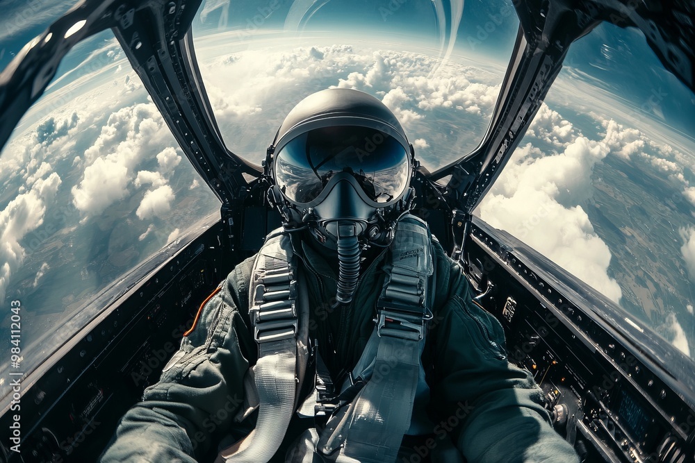 Fototapeta premium Selfie portrait of a fighter pilot wearing helmet and black glasses inside the plane flying high in the sky, view from the cockpit of a fighter jet with space for text or inscriptions
