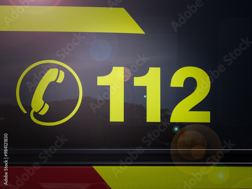 Emergency Hotline 112: Reflective Safety Sign on Rescue Vehicle