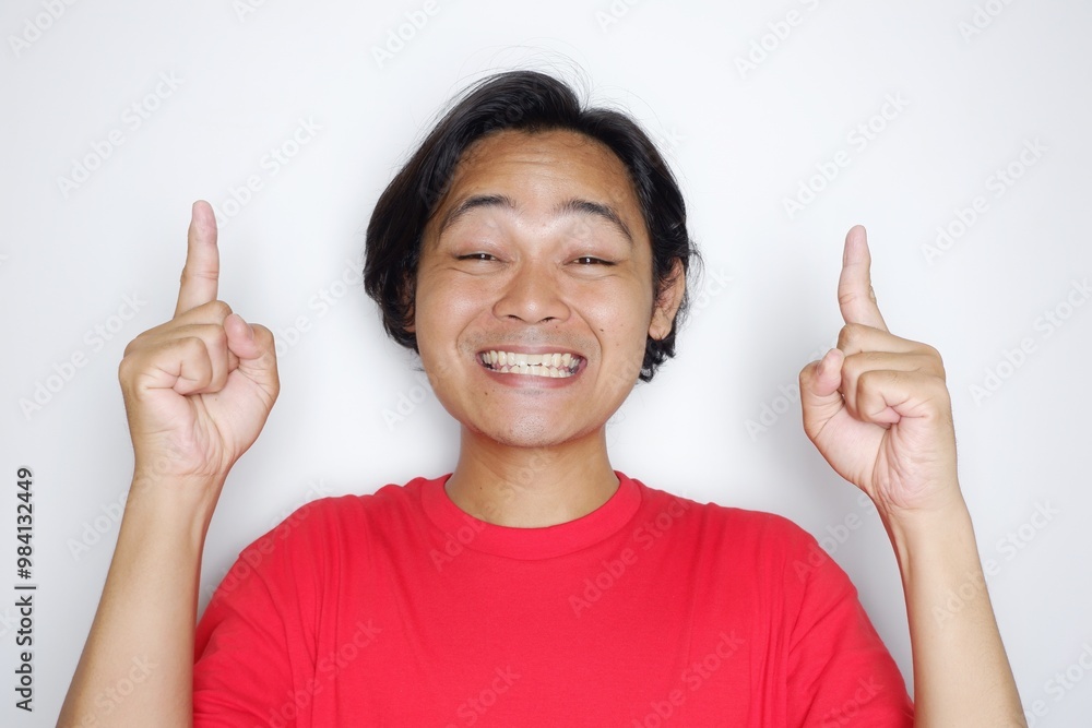 Portrait of an Indonesian man with long hair with a headband and red shirt celebrating Indonesian Independence Day with high nationalism on an isolated white background Portrait of an Indonesian man with long hair with a headband and red shirt celebrating Indonesian Independence Day with high nationalism on an isolated white background