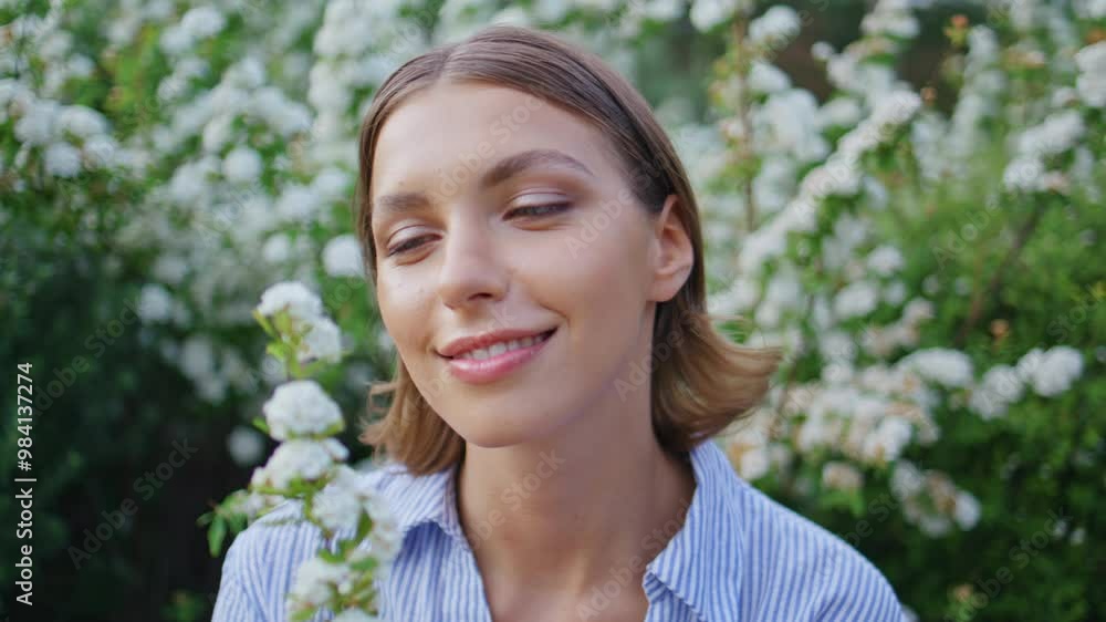 Lady enjoying flowers fragrance in beautiful garden closeup. Smiling happy woman Lady enjoying flowers fragrance in beautiful garden closeup. Smiling happy woman