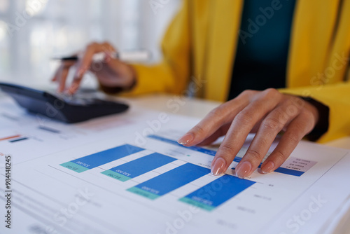 Close up of female hand accountan using a laptop computer and calculator to calculate taxes at desk in the office financial business, calculating accounting online marketing. photo