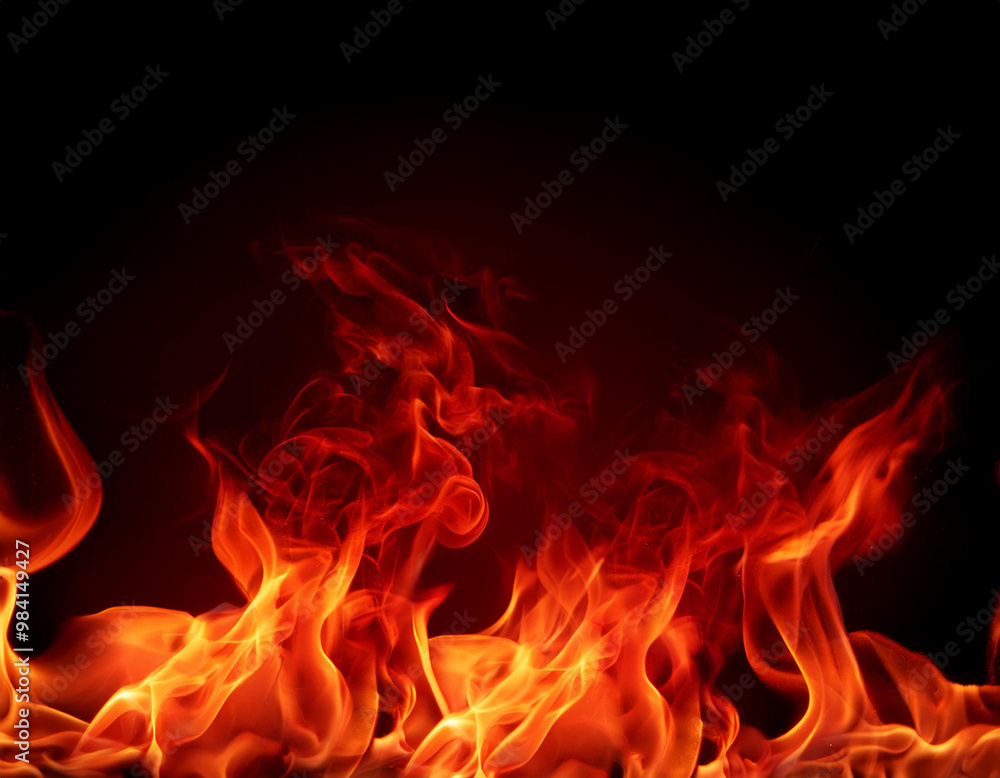 Fototapeta premium Red hot fire flames on black background; copy space, banner; soft focus
