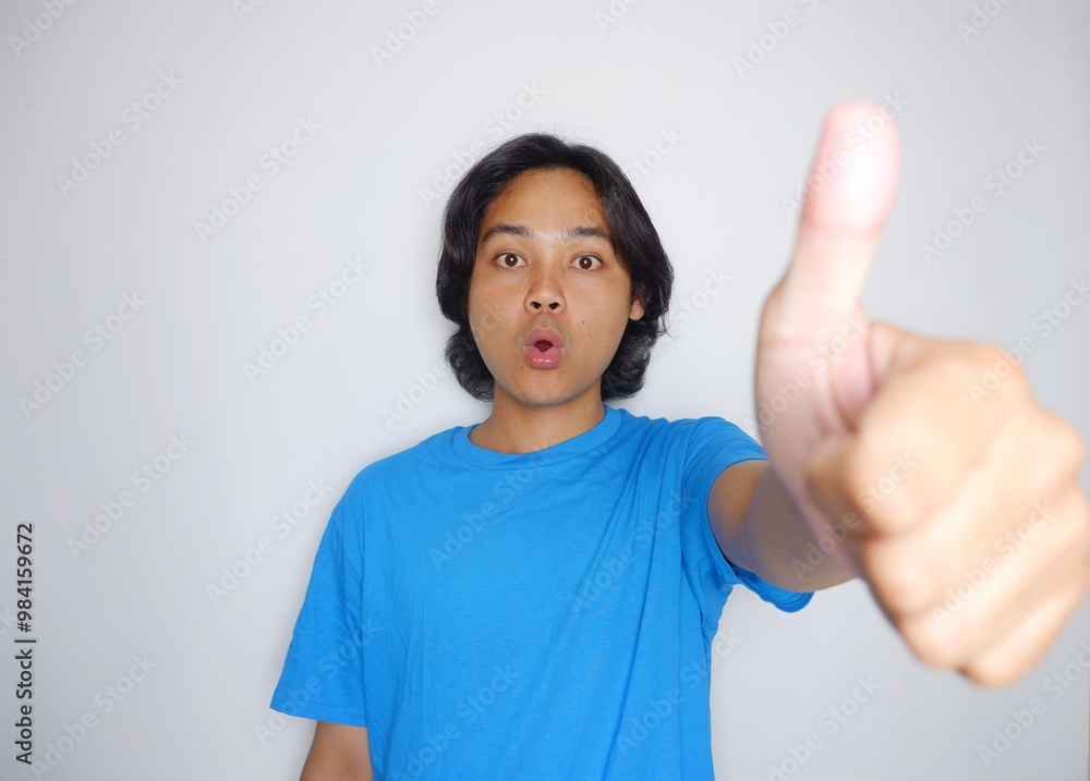 Portrait of a handsome Indonesian man wearing a plain black shirt with a random pose isolated on a white background Portrait of a handsome Indonesian man wearing a plain black shirt with a random pose isolated on a white background