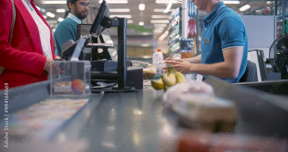 Male Cashier Scanning Product Items for Diverse Customers at a Busy ...
