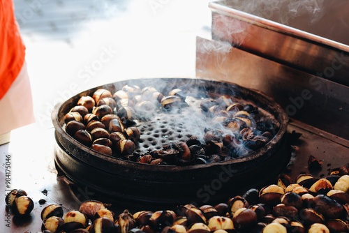 Steaming roasted chestnuts, Istanbul streetfood; cooking outdoors. Popular autumn and winter street food.  photo