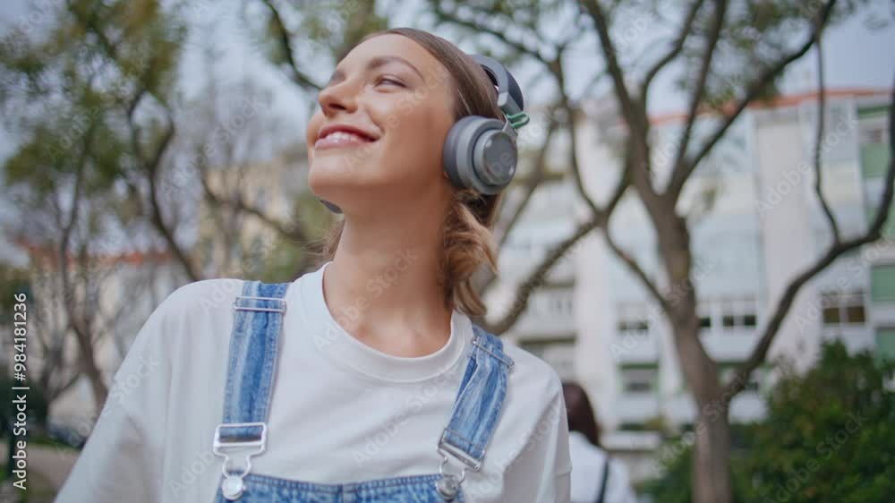Happy woman enjoying music in headphones walking park closeup. Carefree hipster Happy woman enjoying music in headphones walking park closeup. Carefree hipster