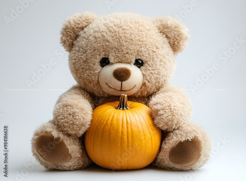 a teddy bear holding a pumpkin. 