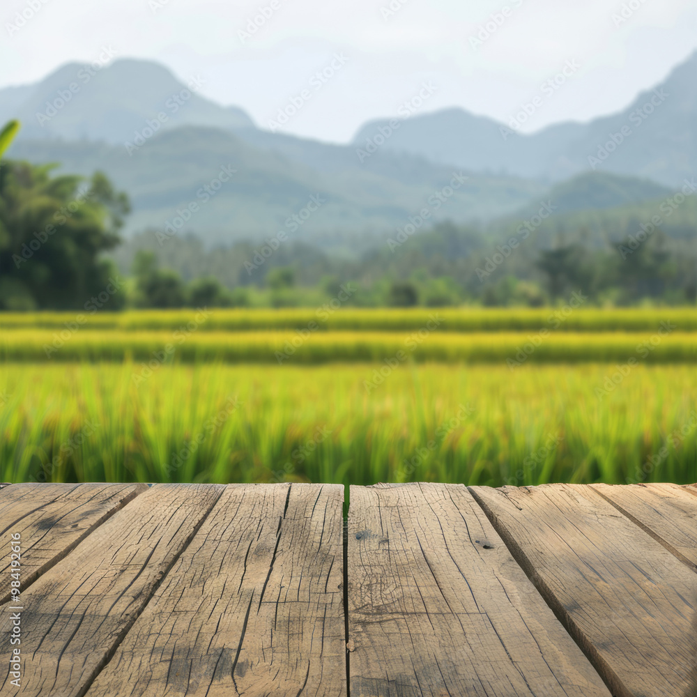 Empty wooden table top with blurred rice fields and mountain background for product display presentation mockup in a sunny day. Empty wooden table top with blurred rice fields and mountain background for product display presentation mockup in a sunny day.