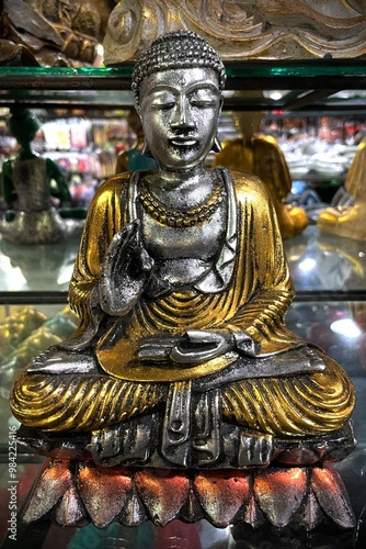 A Buddha statue standing on display in a souvenir shop