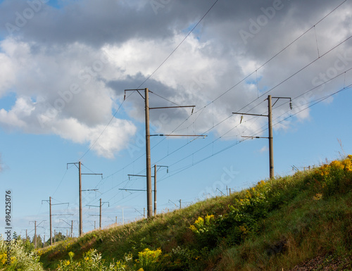 A field with a lot of power lines and a few trees