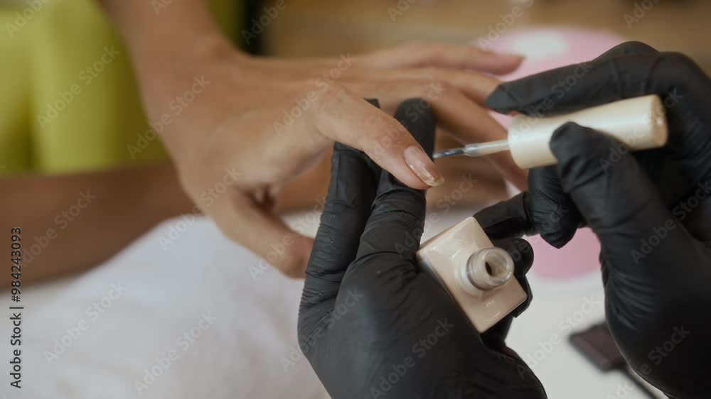Close up of hands of anonymous specialist manicuring nails of client with polish at salon Close up of hands of anonymous specialist manicuring nails of client with polish at salon