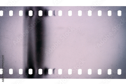 Dusty and grungy 35mm film texture or surface. Perforated scratched camera film isolated on white background.