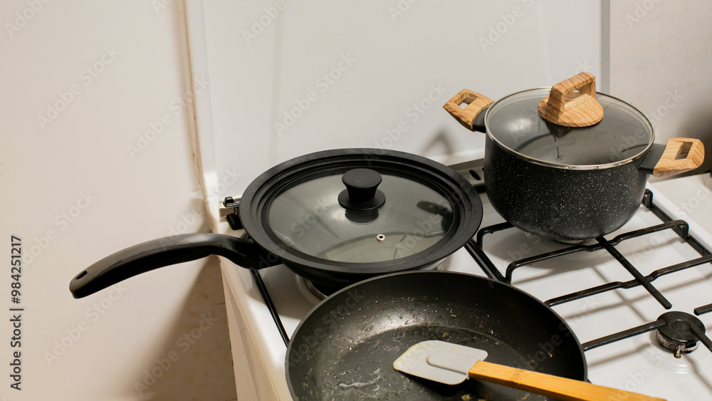Modern kitchen gas stove with pots and frypan, ideal for cooking concepts and Mother's Day meal preparations Modern kitchen gas stove with pots and frypan, ideal for cooking concepts and Mother's Day meal preparations