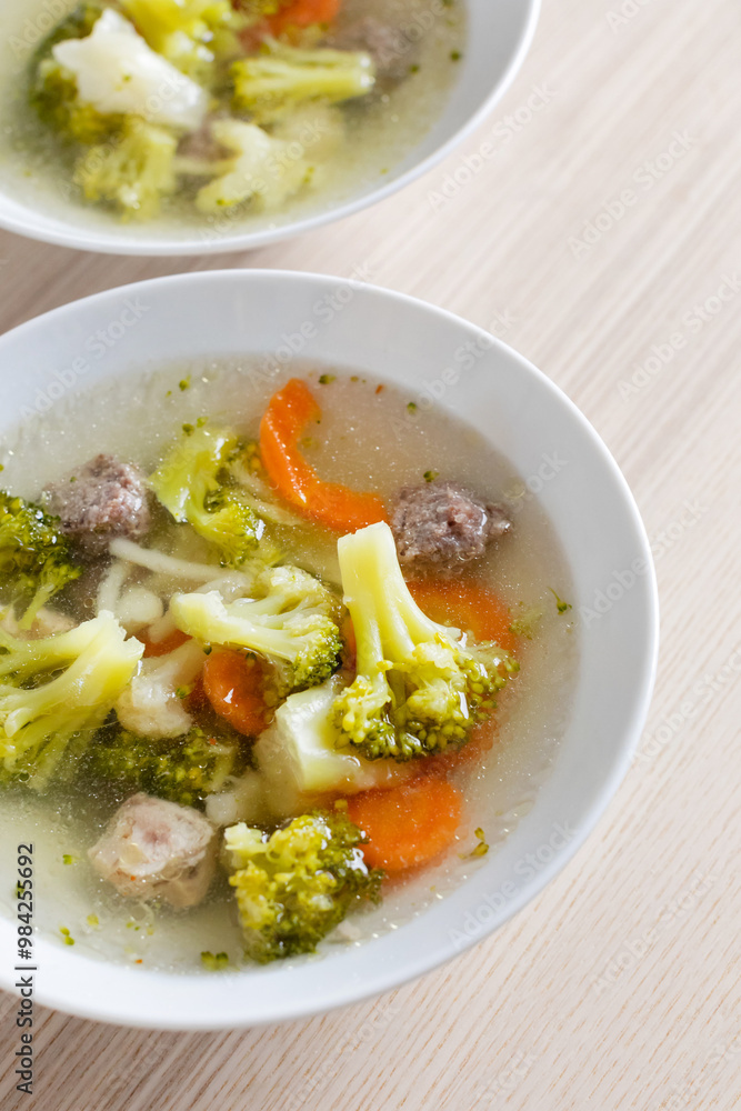 A comforting bowl of homemade vegetable and meatball soup perfect for a healthy winter meal or flu recovery A comforting bowl of homemade vegetable and meatball soup perfect for a healthy winter meal or flu recovery