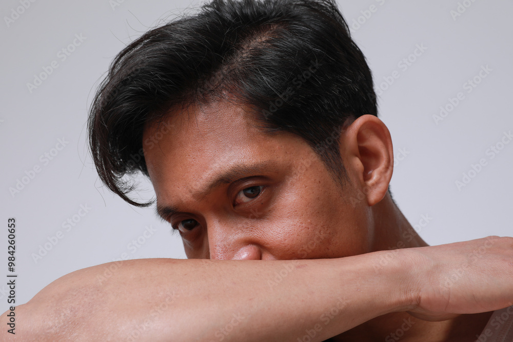 Portrait of handsome asian man posing over white background looking at the camera. Portrait of handsome asian man posing over white background looking at the camera.