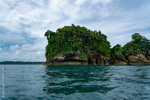 Tropical Island in Panama’s Caribbean Coastline with Lush Greenery, Rugged Cliffs, and Diverse Wildlife Surrounded by Turquoise Ocean Waters – Perfect for Nature and Adventure Photography photo