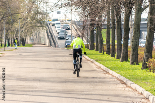 Wallpaper Mural Сyclist rides on the road in the city. Torontodigital.ca