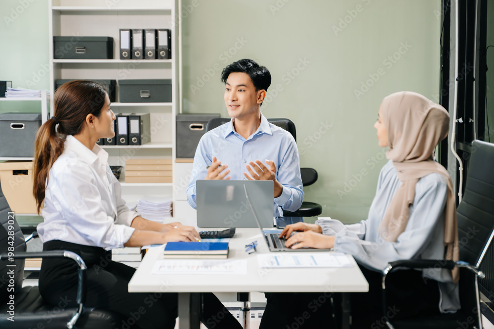 Happy businesspeople while collaborating on a new project in an office. Happy businesspeople while collaborating on a new project in an office.