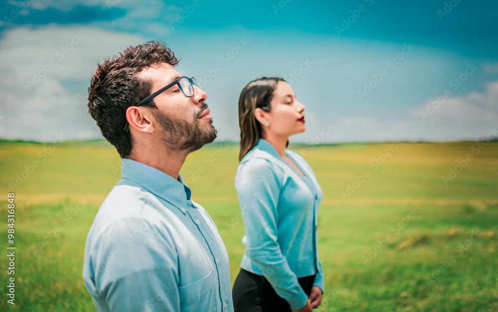 Young couple breathing fresh air in the field. Two relaxed people breathing fresh air in the countryside Young couple breathing fresh air in the field. Two relaxed people breathing fresh air in the countryside