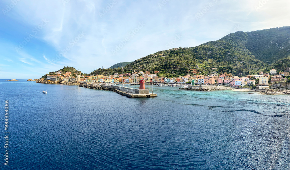 Obraz premium View to harbour and old town of Giglio Porto at Isola del Giglio, island of the tuscan archipelago, beautiful ancient rustico buildings and ferry terminal to Porto San Stefano, Grosseto Tuscany Italy