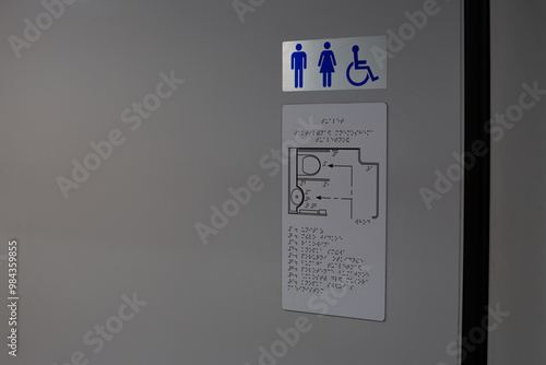 Toilet location sign with diagram of restroom in braille text for person who has lost vision, washroom sign for the disabled, tactile icon for people with disabilities