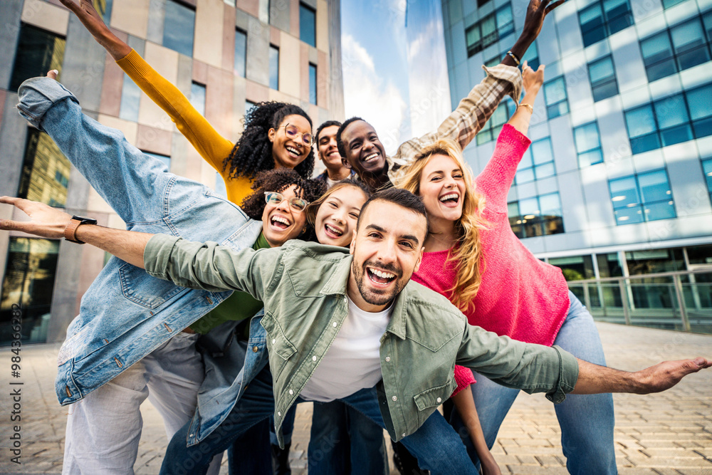 © Davide Angelini - Multi ethnic young people smiling together at camera outdoors - Happy group of friends having fun hanging out in downtown street - University students standing together in college campus