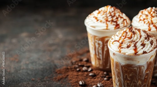 This inviting image showcases three coffee beverages topped with whipped cream and caramel drizzle, arranged on a rustic dark surface, evoking comfort and indulgence with coffee beans scattered aroun photo