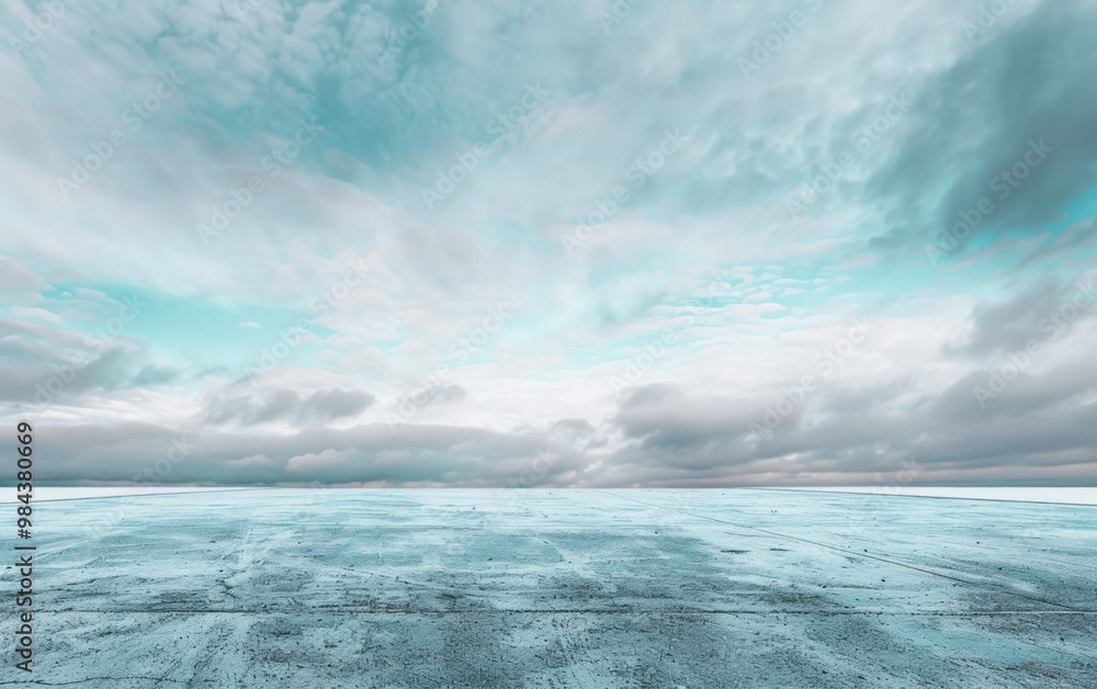 Frozen landscape under a cloudy sky with expansive horizon. Winter and cold weather concept for outdoor scenery. Frozen landscape under a cloudy sky with expansive horizon. Winter and cold weather concept for outdoor scenery.