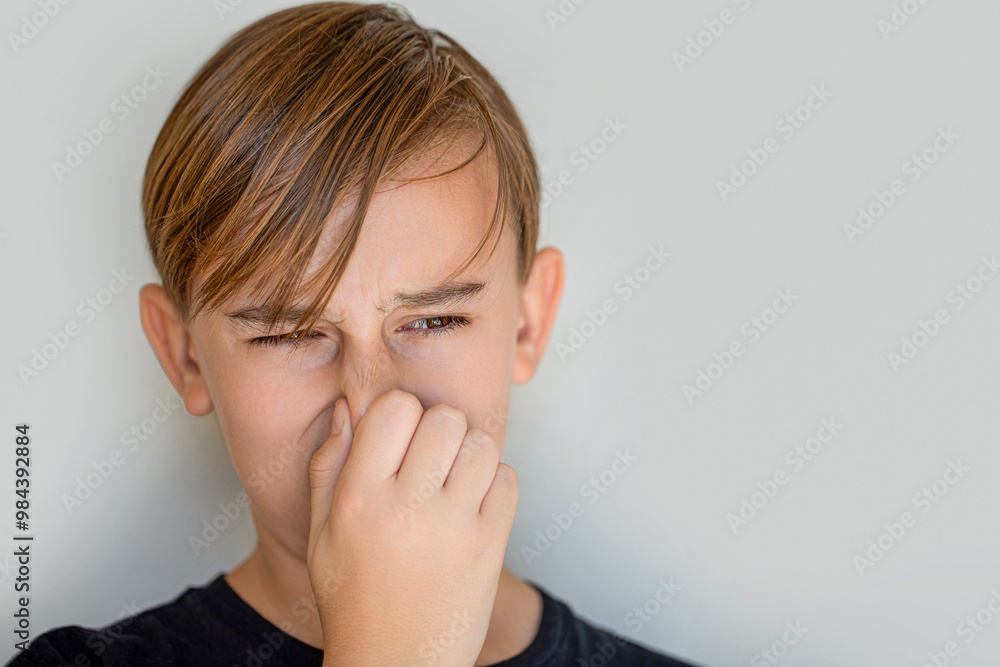 Bad smell expression. Kid smelling stinky and disgusting, intolerable smell, holding breath with fingers on nose, bad smell. Child feeling bad, dislike smell and hold nose from funny odor, stinky Bad smell expression. Kid smelling stinky and disgusting, intolerable smell, holding breath with fingers on nose, bad smell. Child feeling bad, dislike smell and hold nose from funny odor, stinky