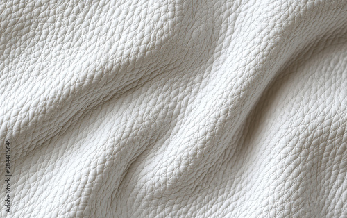 Close-up of textured white leather fabric with subtle wrinkles, ideal for background or abstract design concept.