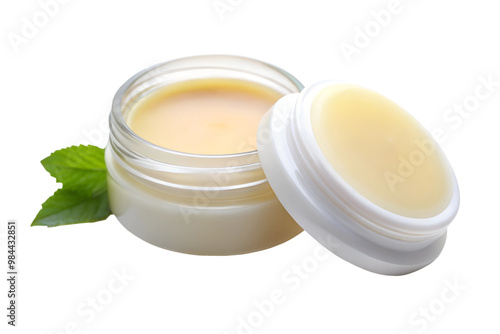 Natural lip balm in glass jar with green leaves isolated on transparent background