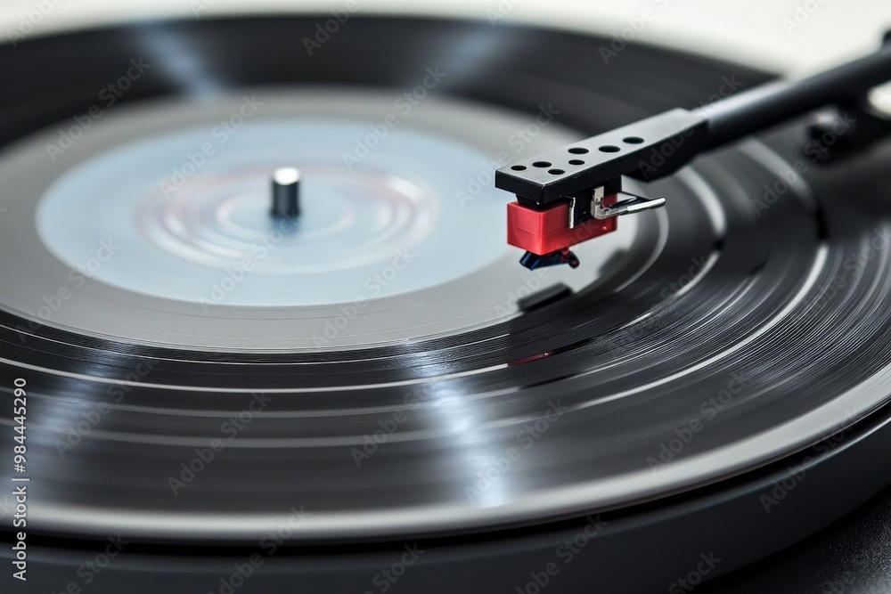 A detailed image of a turntable stylus in action, tracking over the grooves of a vinyl record, emphasizing the precision and elegance of analog music playback. A detailed image of a turntable stylus in action, tracking over the grooves of a vinyl record, emphasizing the precision and elegance of analog music playback.
