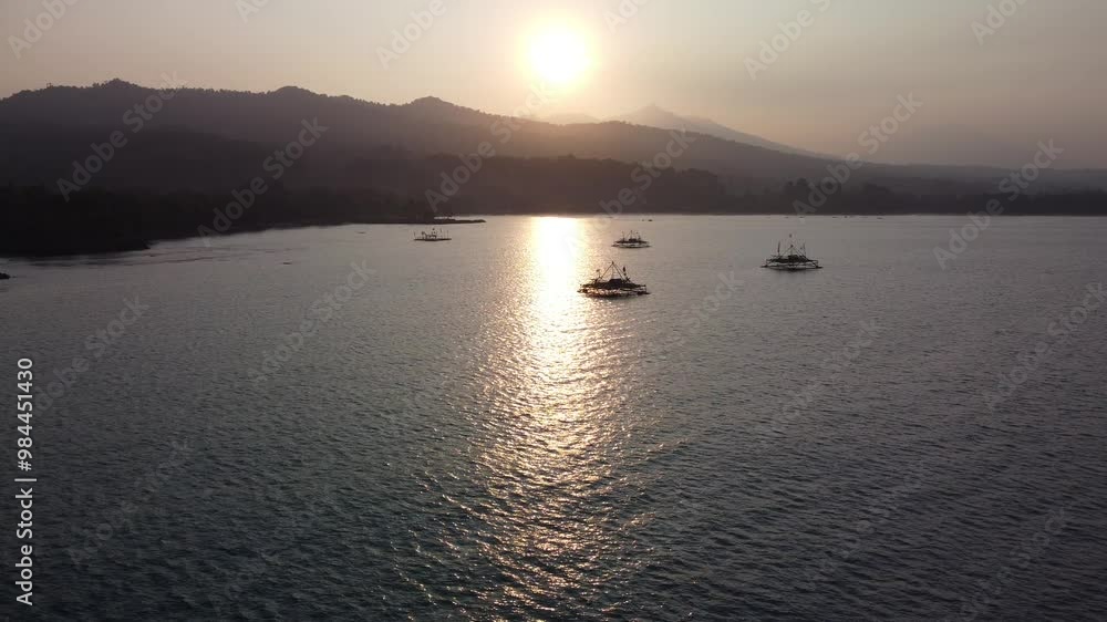 The rising drone shows a view of the sunrise over the ocean over the mountains. Reflection of sunlight on the sea. Sunset on the Beach. The rising drone shows a view of the sunrise over the ocean over the mountains. Reflection of sunlight on the sea. Sunset on the Beach.