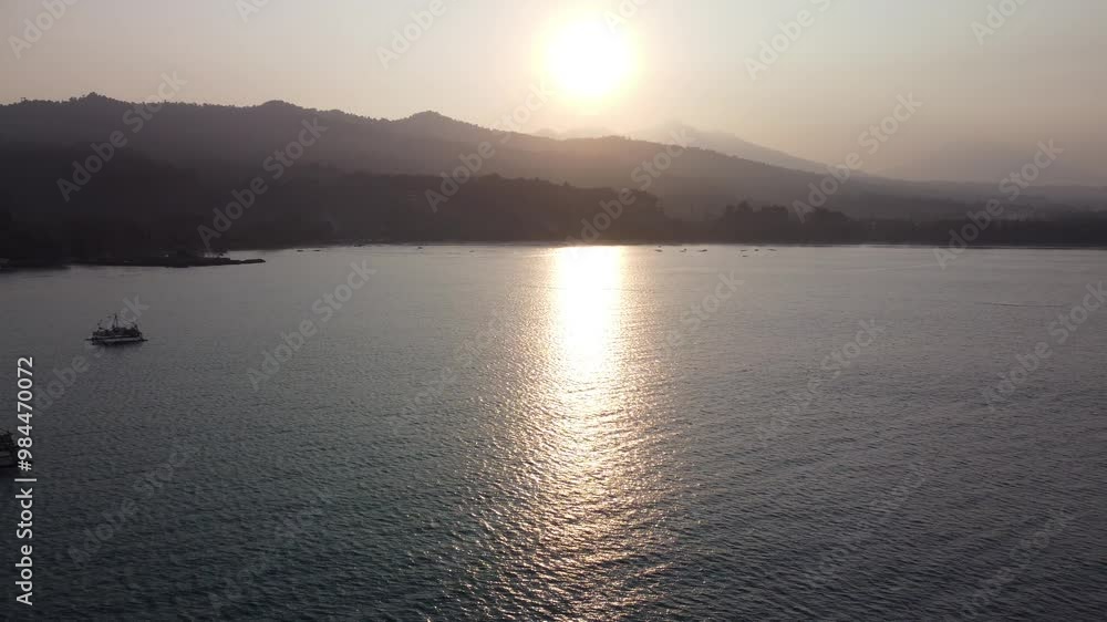 Aerial view of sunrise horizon over sea. Cinematic drone aerial view of beautiful evening sunset in the sky over the sea. The sun's path is reflected on the sea surface. Natural beauty. Aerial view of sunrise horizon over sea. Cinematic drone aerial view of beautiful evening sunset in the sky over the sea. The sun's path is reflected on the sea surface. Natural beauty.