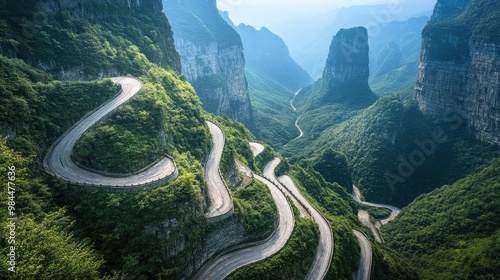 A panoramic view of the road winding up Tianmen Mountain towards HeavenGate, with sharp hairpin turns and steep cliffs on either side.