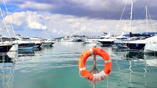 Photo of numerous luxury private yachts docked at Marina Flisvos in Palaio Faliro in a cloudy autumn morning. photo