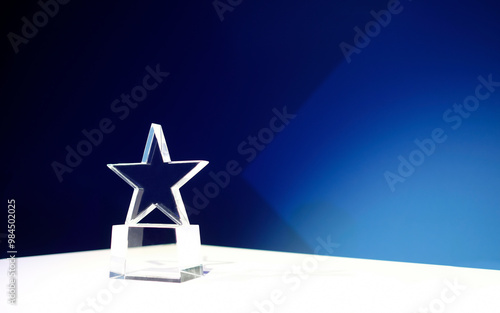 Star-shaped award on a table with spotlights and copy space
