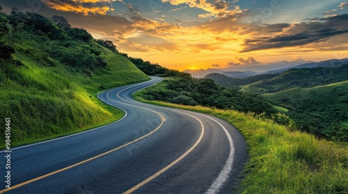 A winding road through lush green hills at sunset, showcasing natural beauty and tranquility.