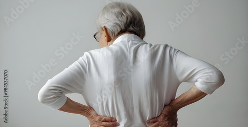 Old woman holding her back