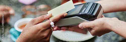Website banner of woman tapping golden credit card to pay for food