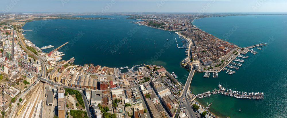Fototapeta premium Aerial panoramic view of Taranto, one of the most important cities in Puglia, Italy. The Gulf of Taranto overlooks the Ionian Sea.