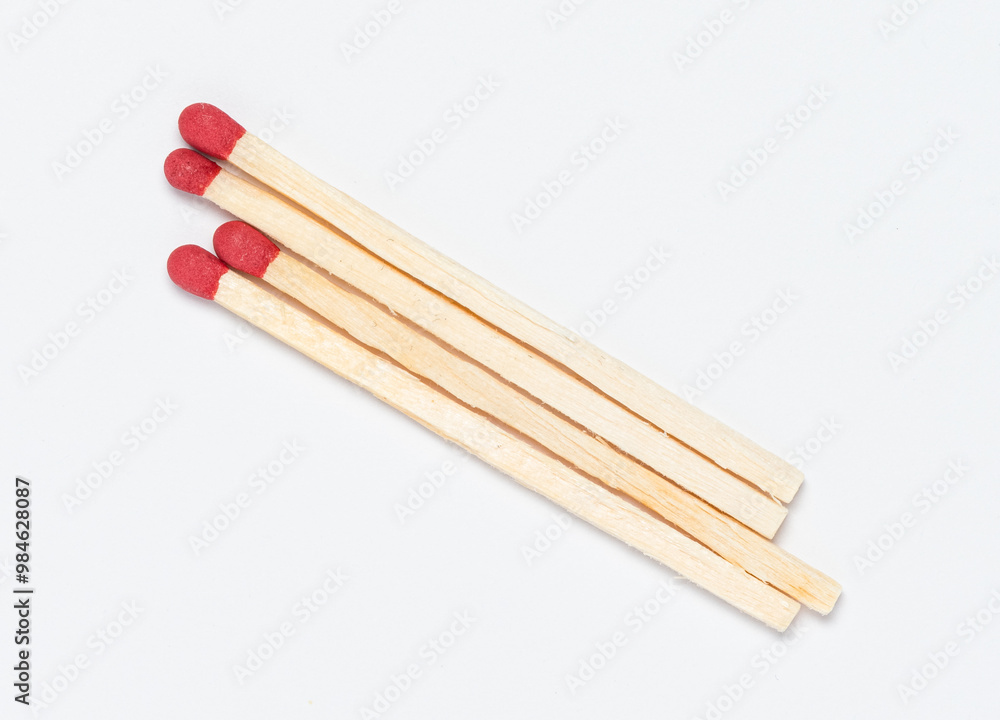 Matchsticks with red tip on white background, close-up top view from above Matchsticks with red tip on white background, close-up top view from above