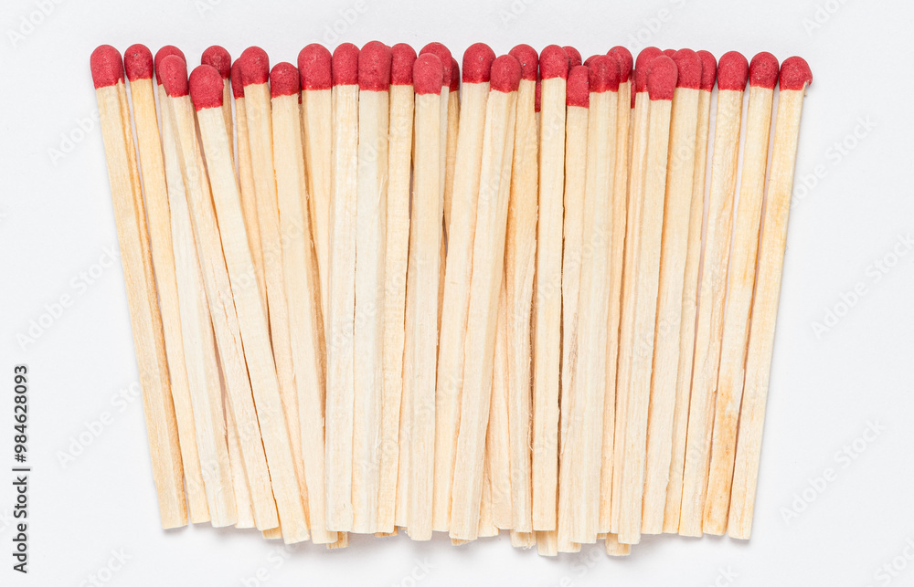 Matchsticks with red tip on white background, close-up top view from above Matchsticks with red tip on white background, close-up top view from above