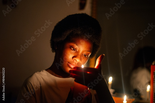 Keep Your Lamps Burning.A young woman holding a candle in the dark