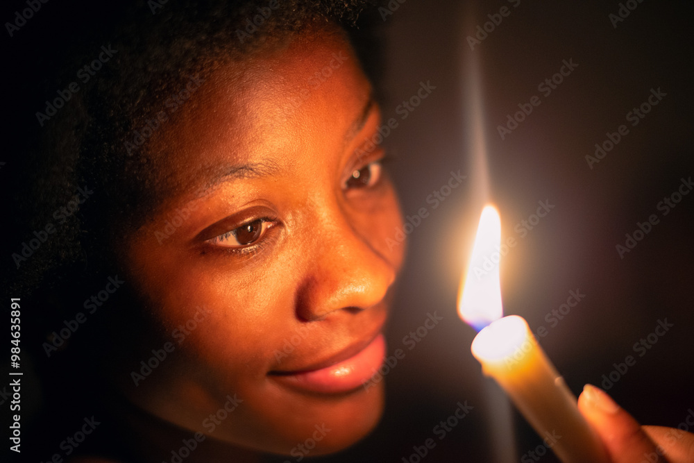 Keep Your Lamps Burning.A young woman holding a candle in the dark Keep Your Lamps Burning.A young woman holding a candle in the dark