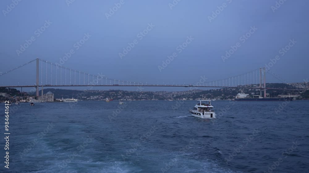Bosphorus Bridge Shot from a Cruising Ferry in the Evening. Istanbul Bridge Connecting Europe to Asia in Turkey. Concept of Bosphorus Cruise Tour, Sightseeing, Travel, 15 July Martyrs Bridge Bosphorus Bridge Shot from a Cruising Ferry in the Evening. Istanbul Bridge Connecting Europe to Asia in Turkey. Concept of Bosphorus Cruise Tour, Sightseeing, Travel, 15 July Martyrs Bridge