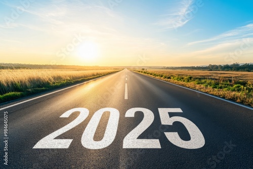 Wallpaper Mural A long empty highway stretches toward the horizon, featuring "2025" painted in bold white letters, leading into a glowing sunrise that symbolizes a hopeful future. Bright lighting captures the sun ris Torontodigital.ca