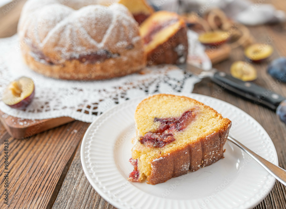 Delicious homemade plum bundt cake on rustic and wooden table background. Delicious homemade plum bundt cake on rustic and wooden table background.