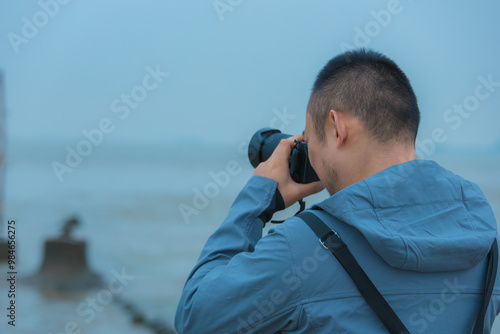 Chongming District, Shanghai - Young people on the beach under the blue sky photo