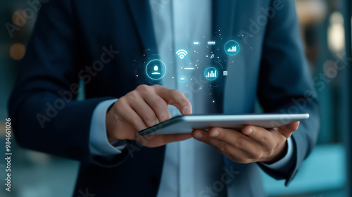 Wallpaper Mural Close-up of a person using a tablet displaying virtual data icons, illustrating digital business solutions and information management. Torontodigital.ca